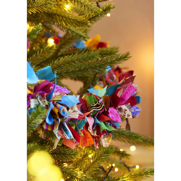 Multicoloured recycled sari tinsel garland hanging as eco-friendly party decoration

